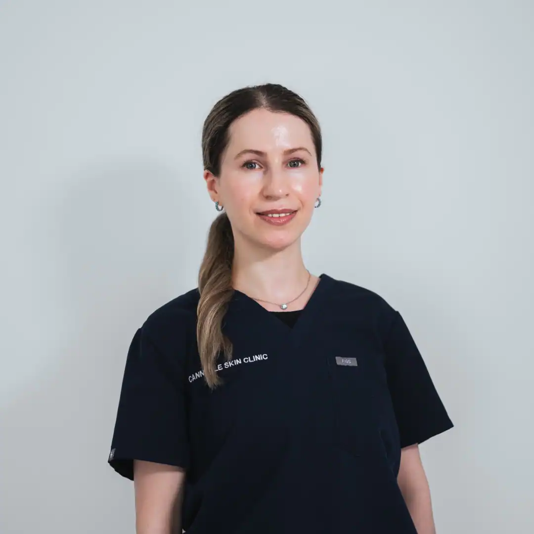 Professional staff member at Cannelle Skin Clinic in uniform, smiling confidently.