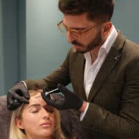 Professional skincare specialist performing facial treatment at Cannelle Skin Clinic.