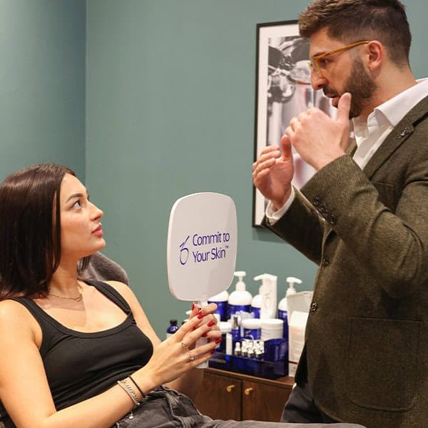 Woman receiving skin consultation at Cannelle Skin Clinic, professional skincare advice.