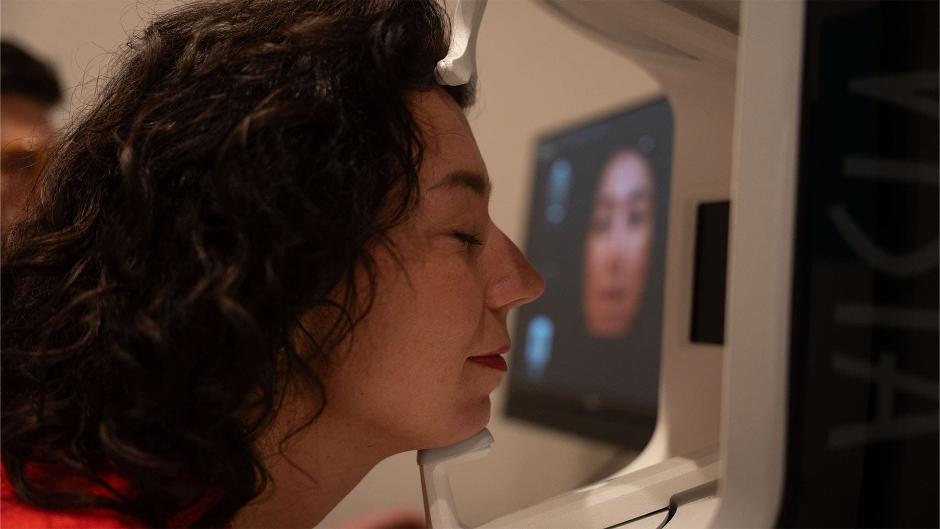 Woman undergoing skin analysis with advanced imaging technology at Cannelle Skin Clinic.