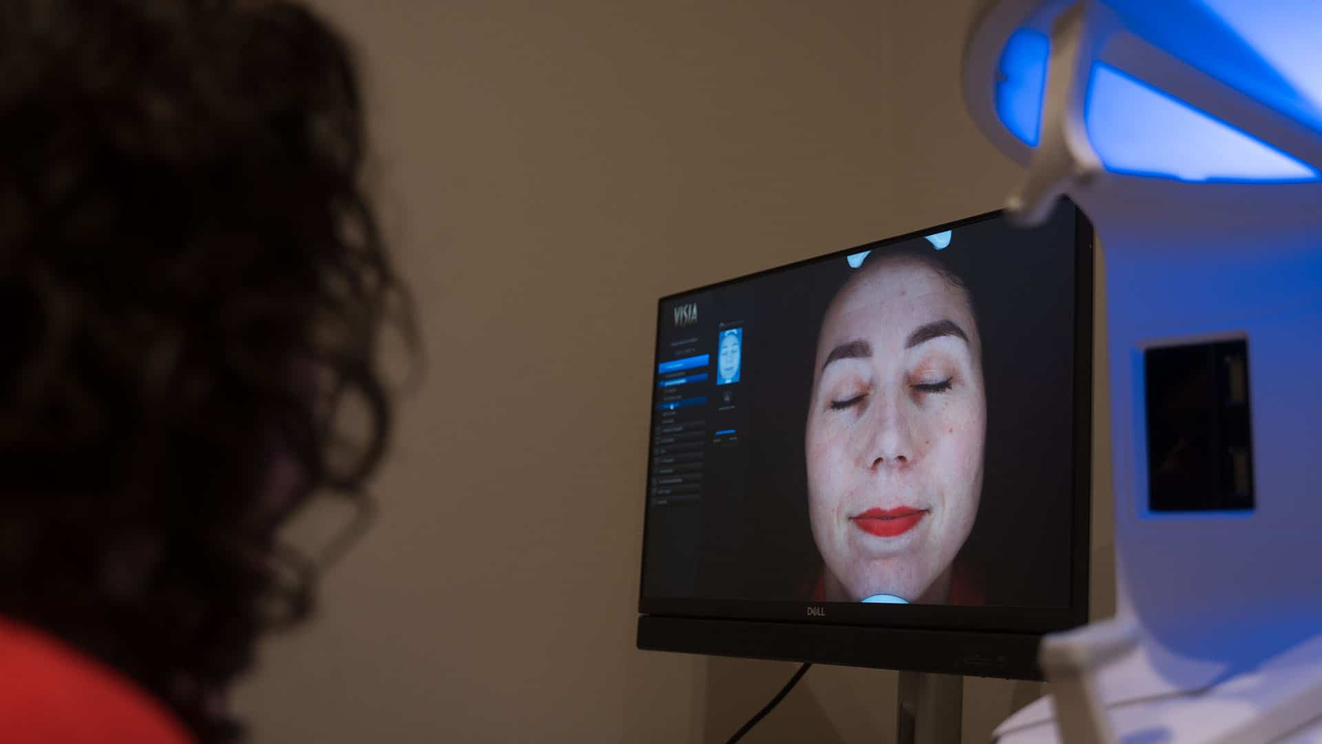 Close-up of a woman receiving a facial treatment with a digital skin analysis device at Cannelle Ski.
