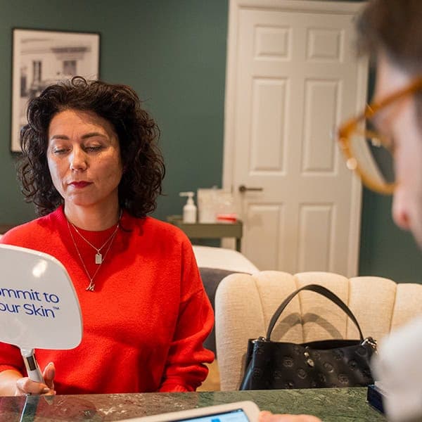 Woman receiving skin consultation at Cannelle Skin Clinic in a professional setting.