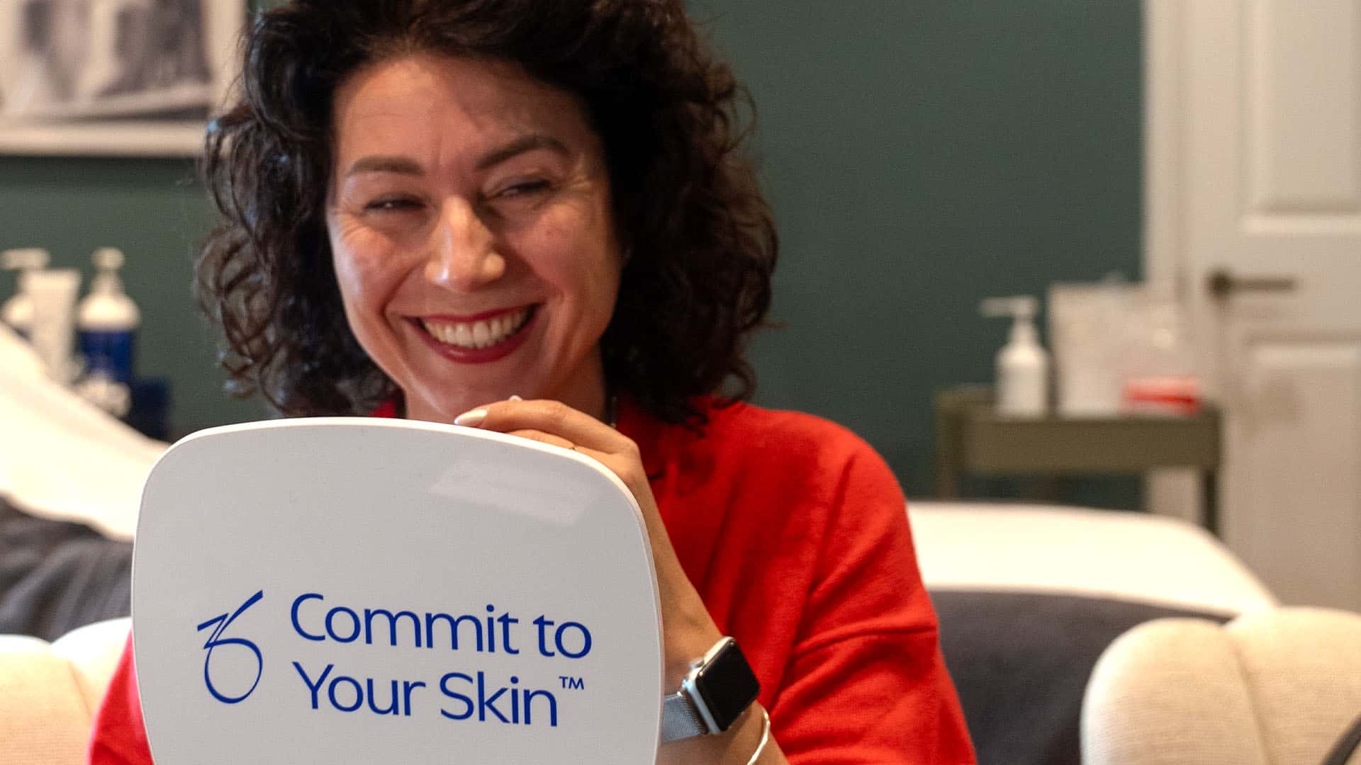Woman smiling during skin consultation at Cannelle Skin Clinic, professional skincare advice.