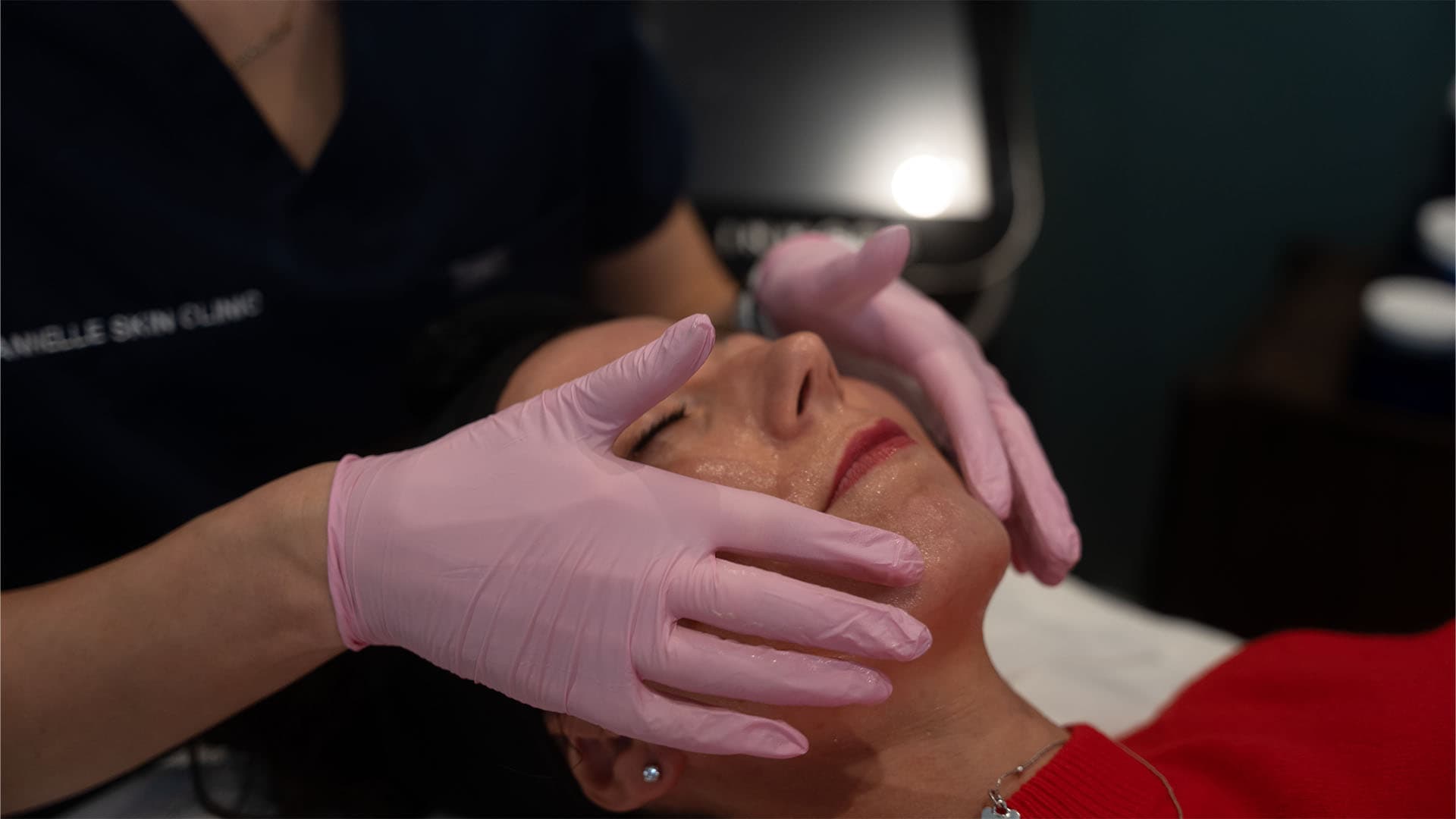 Woman receiving a facial treatment at Cannelle Skin Clinic, skincare specialist performing facial th.