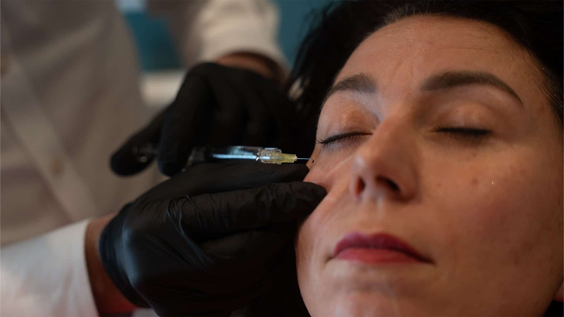 Woman receiving facial injection treatment at Cannelle Skin Clinic, skincare specialist performing c.