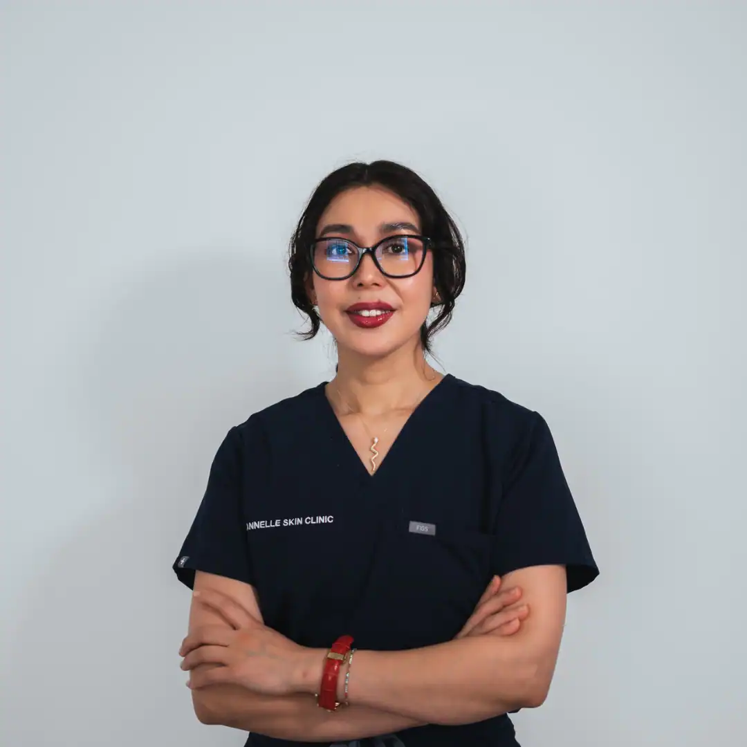 Professional skincare specialist at Cannelle Skin Clinic with confident pose.