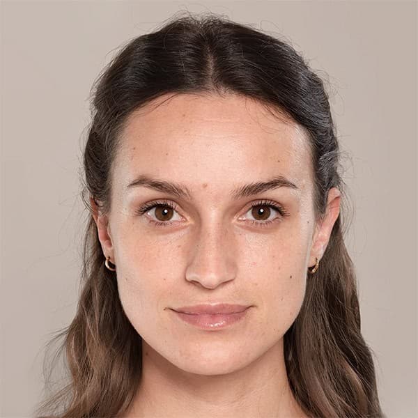 Woman with clear, glowing skin after facial treatment at Cannelle Skin Clinic.