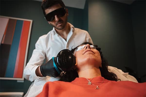 Woman receiving skin treatment with advanced technology at Cannelle Skin Clinic.