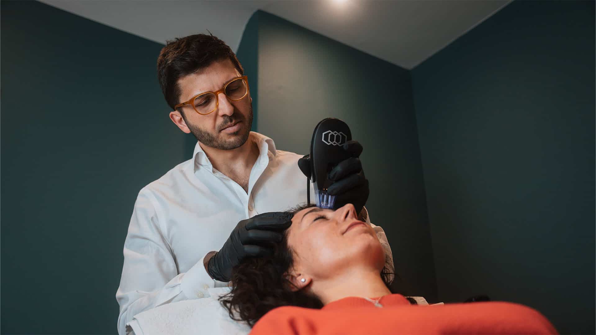 Professional skincare specialist performing a facial treatment on a client in a clinic setting.
