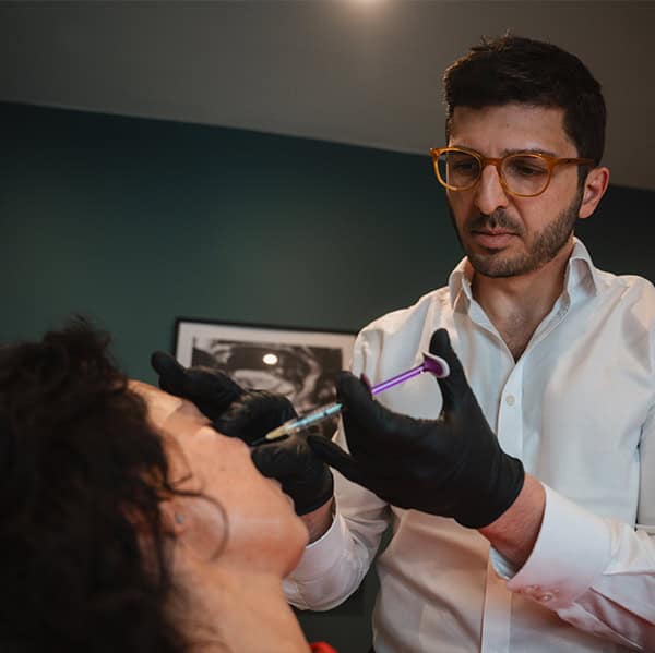 Professional aesthetician performing facial injection treatment at Cannelle Skin Clinic.
