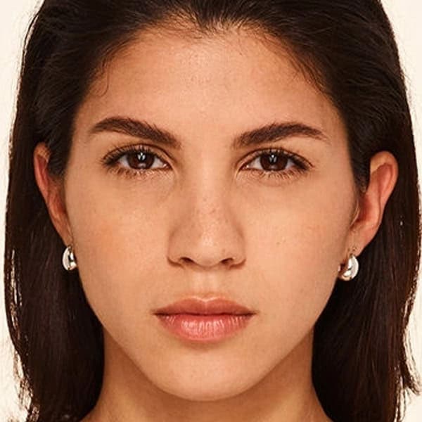 Woman with clear, glowing skin at Cannelle Skin Clinic, skincare treatment in progress.