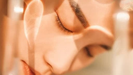 Close-up of a woman receiving a facial treatment at Cannelle Skin Clinic, promoting skincare and rej.