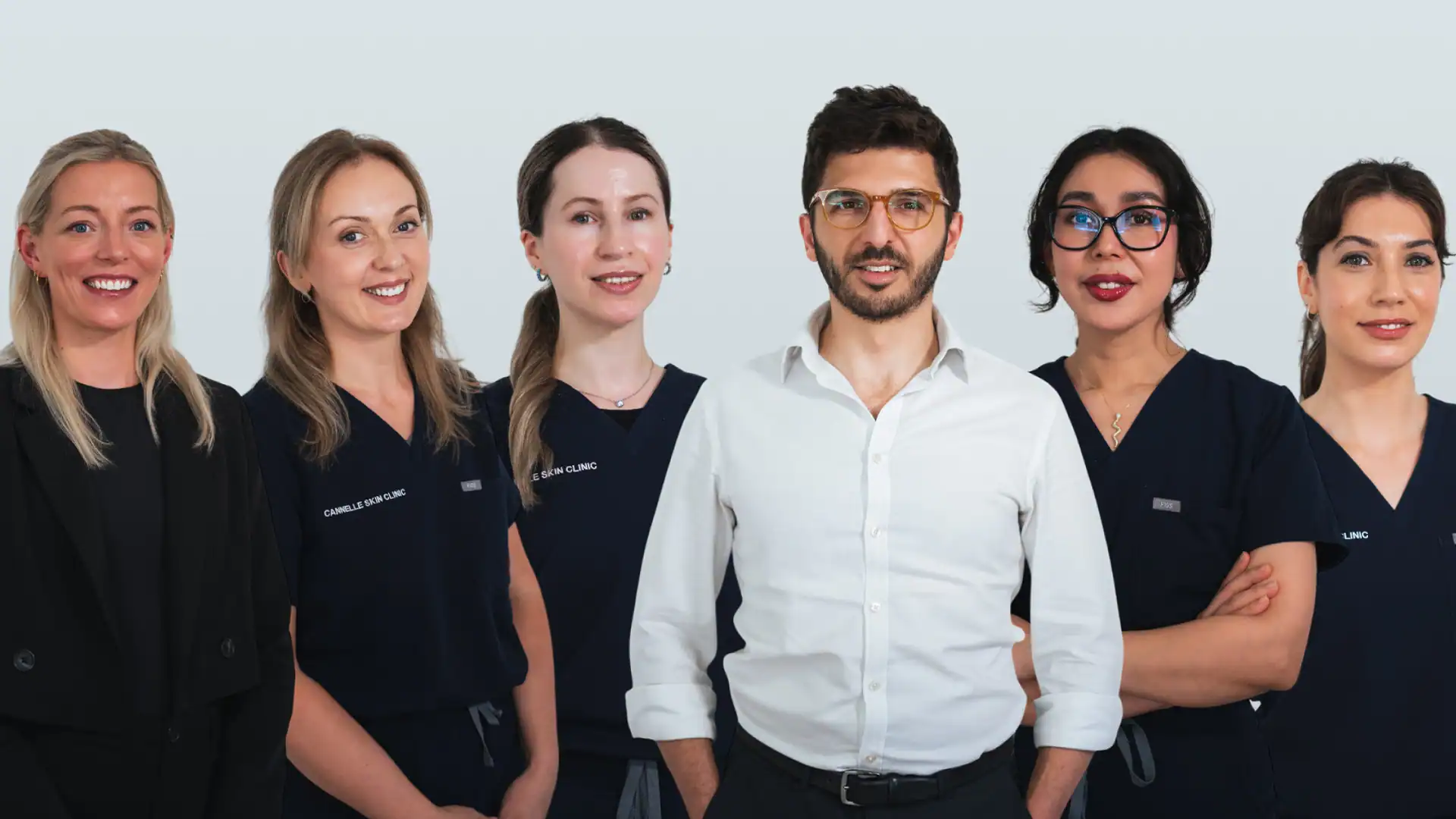 Group of skincare professionals at Cannelle Skin Clinic, smiling and ready to provide expert treatme.
