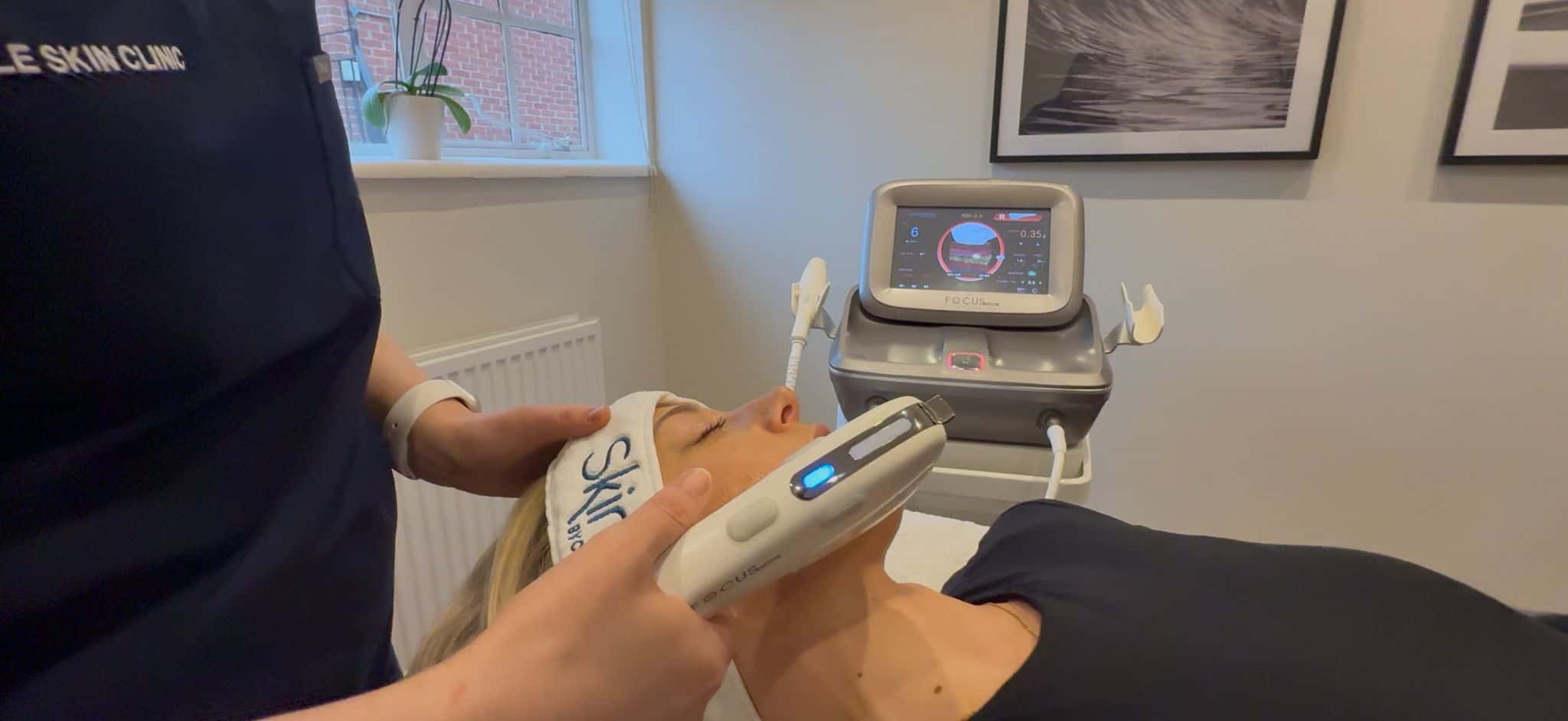 Woman receiving skin rejuvenation treatment with advanced device at Cannelle Skin Clinic.