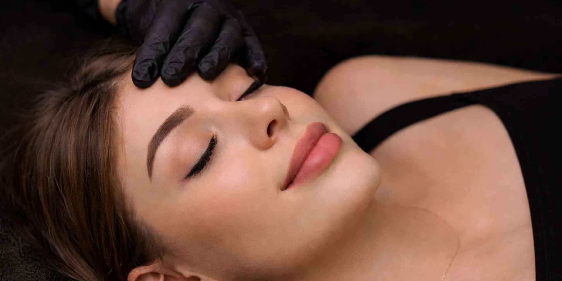 Woman receiving a facial treatment for clear, healthy skin at Cannelle Skin Clinic.