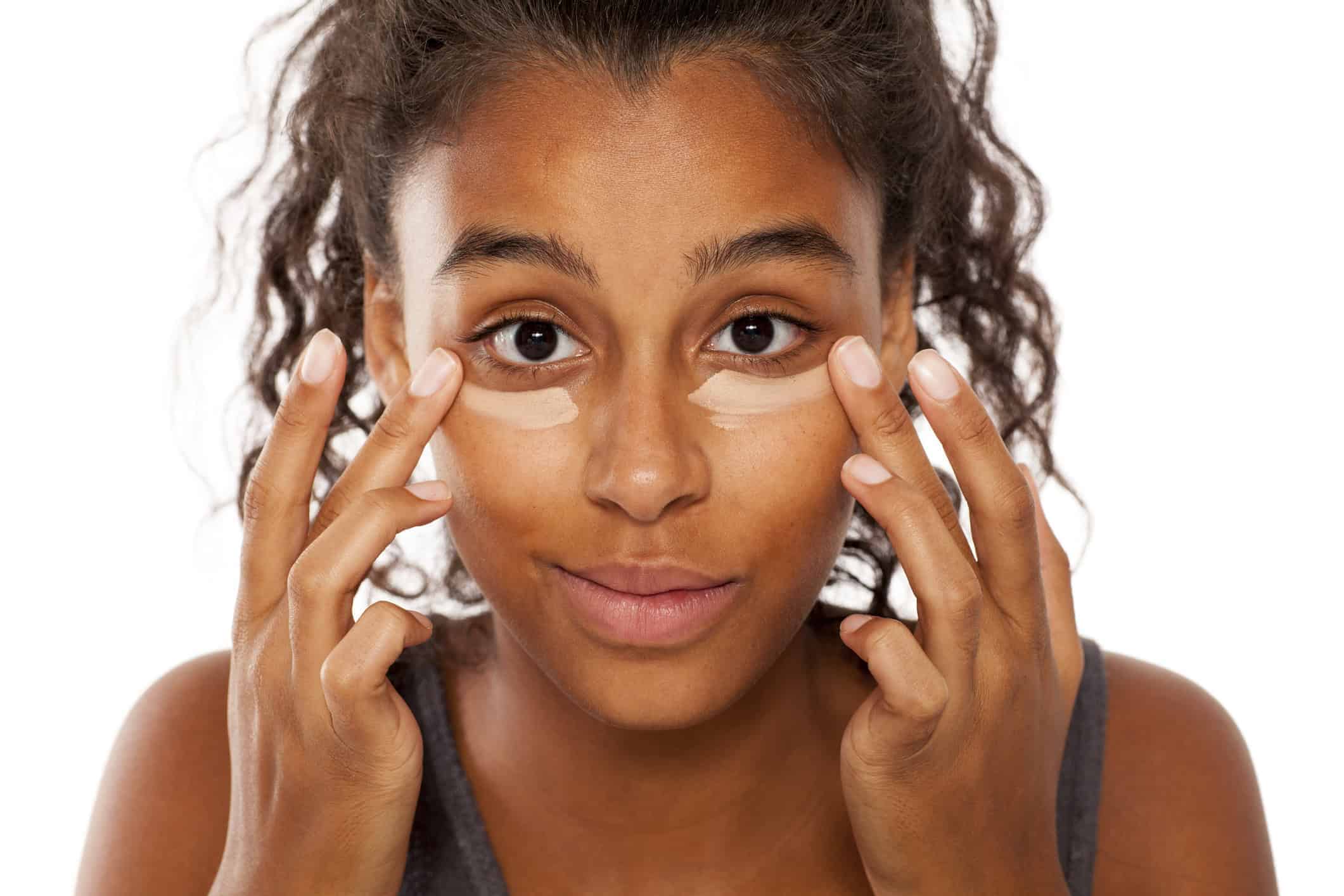 Under-eye cream being applied with a fingertip