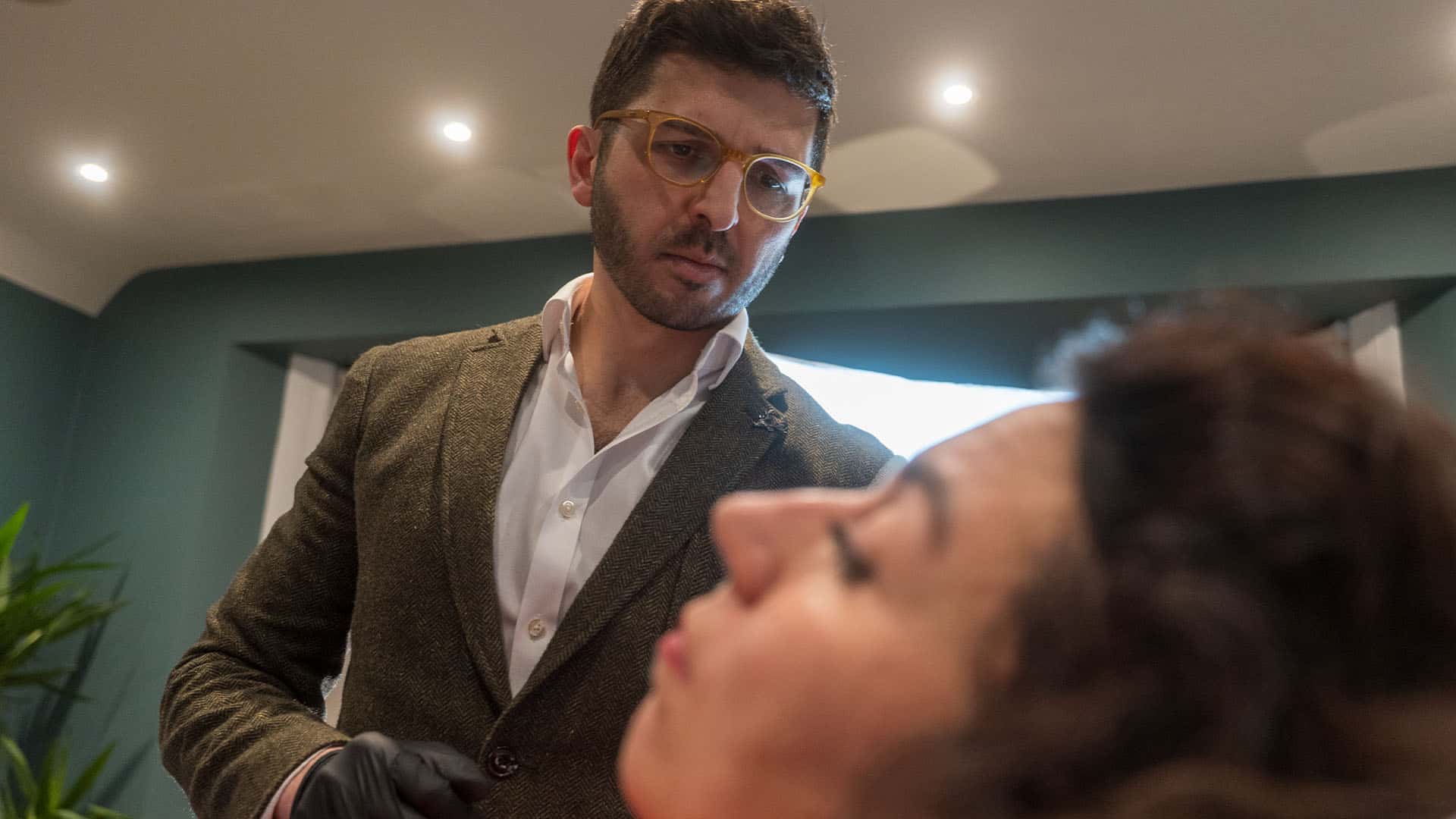 Consultant discussing skincare treatment options with a patient in a professional clinic setting.