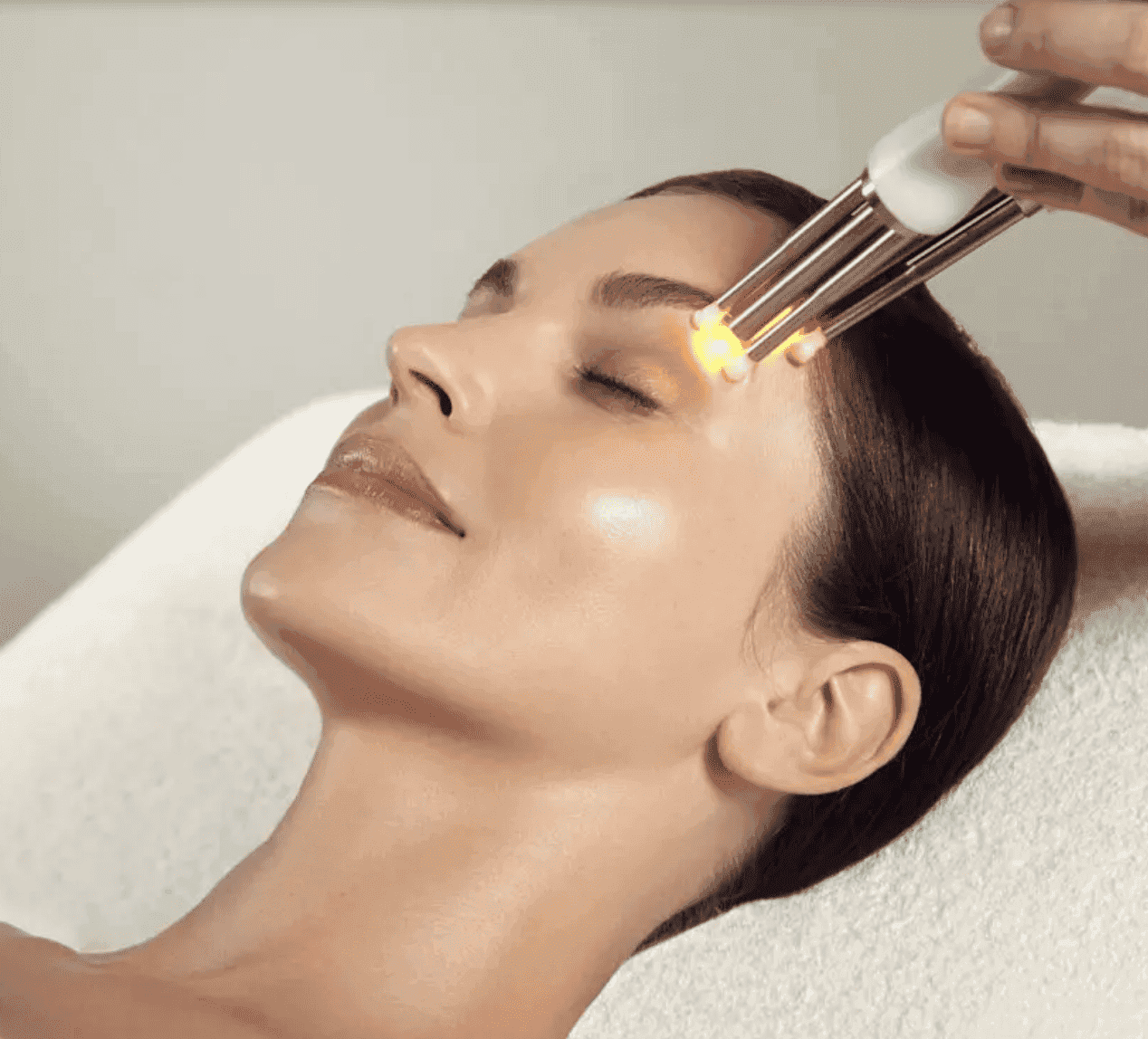 Woman receiving skin rejuvenation treatment with LED therapy at Cannelle Skin Clinic.