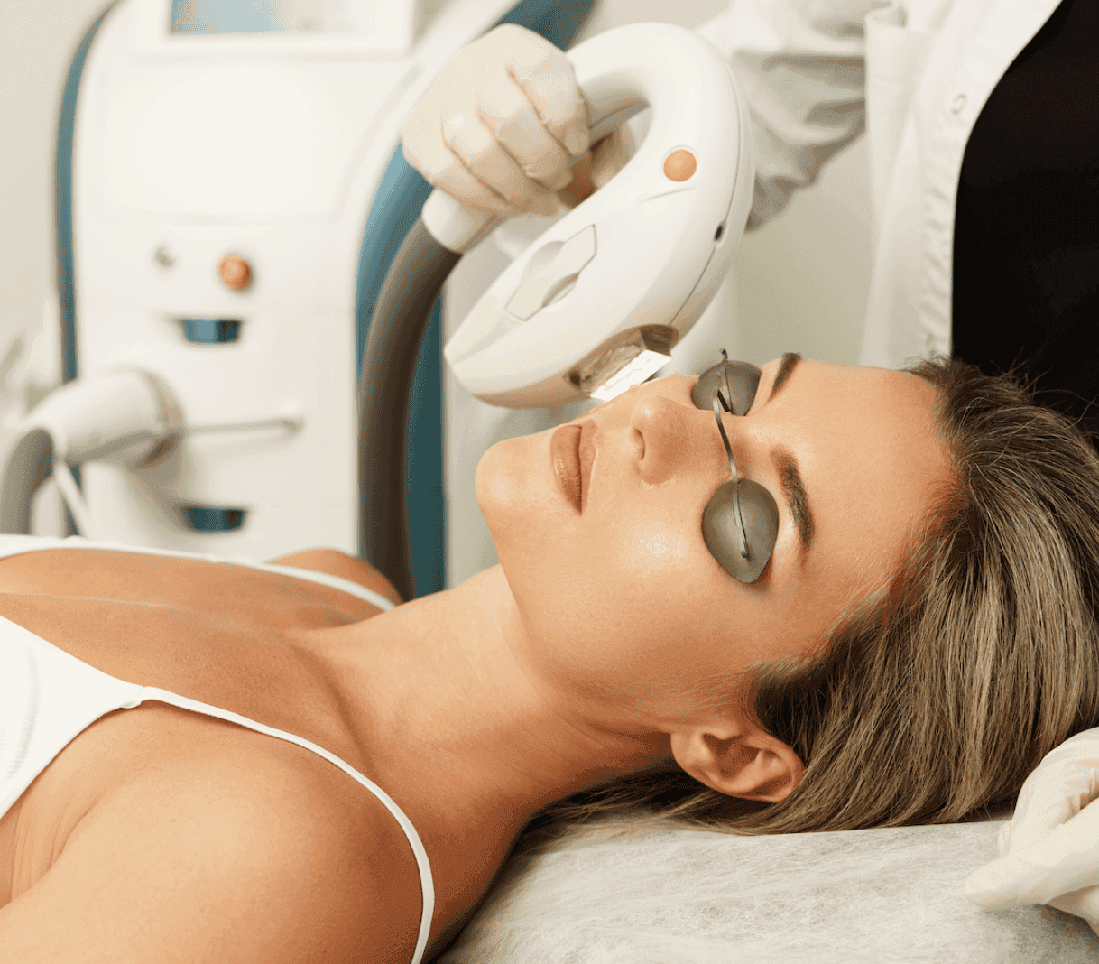 Woman receiving skin rejuvenation treatment with advanced laser technology at Cannelle Skin Clinic.