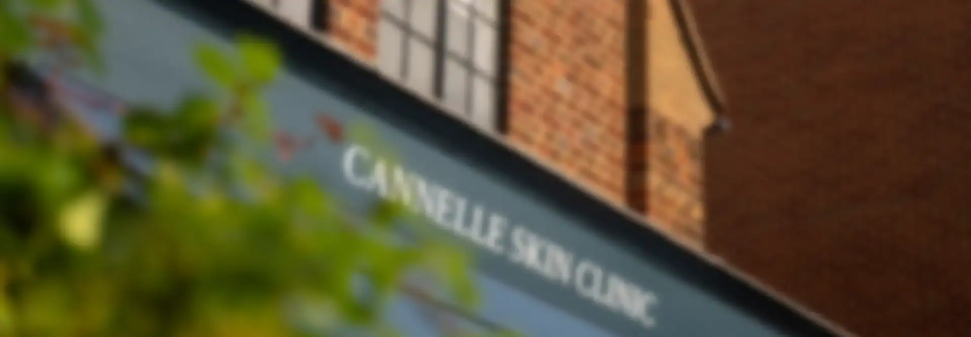 Exterior view of Cannelle Skin Clinic storefront in a brick building.