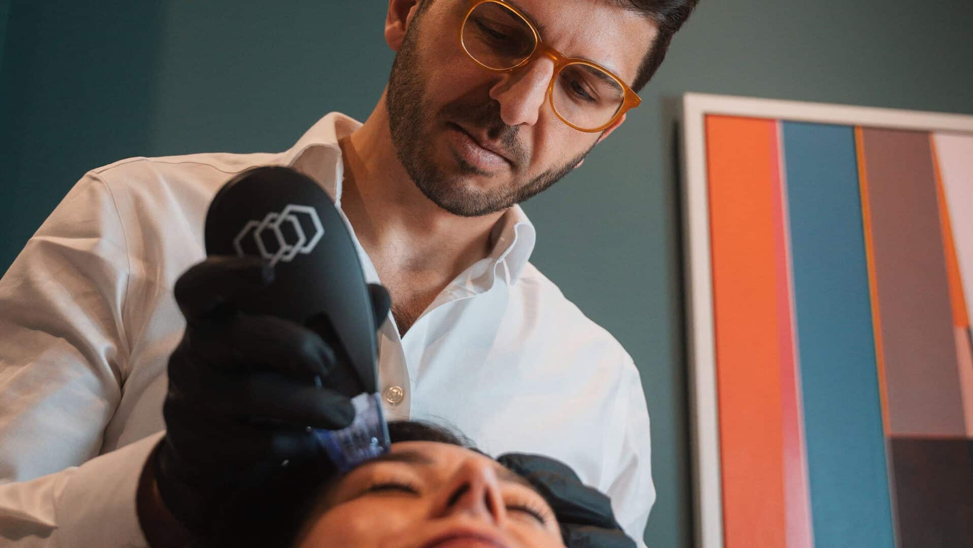 A skincare professional performing a facial treatment at Cannelle Skin Clinic.
