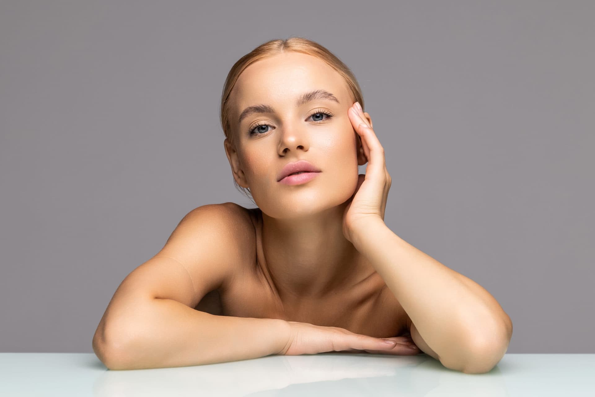 Woman with clear, glowing skin, promoting skincare treatments at Cannelle Skin Clinic.