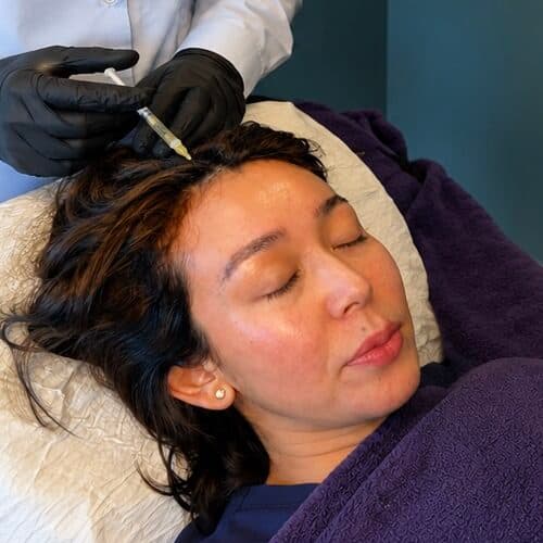 Facial treatment at Cannelle Skin Clinic with a professional aesthetician performing skincare proced.