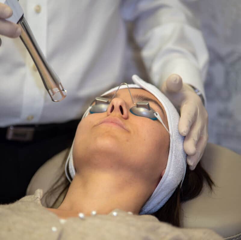 UltraClear laser resurfacing handpiece being used on a patient\'s face