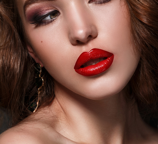 Woman smiling with plump red lips after fillers