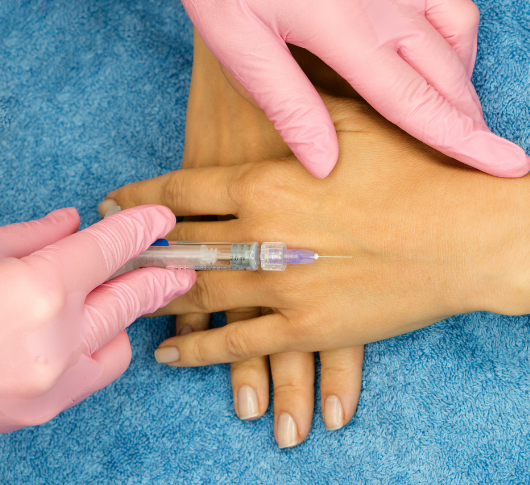 Injecting a rejuvenating anti-ageing solution into the hands