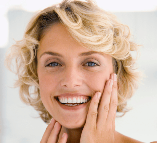 blonde woman touching her face after morpheus treatment
