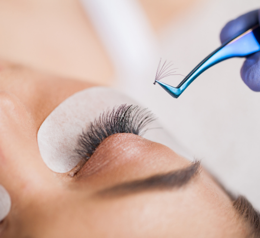Applying eyelash extensions procedure with tweezers