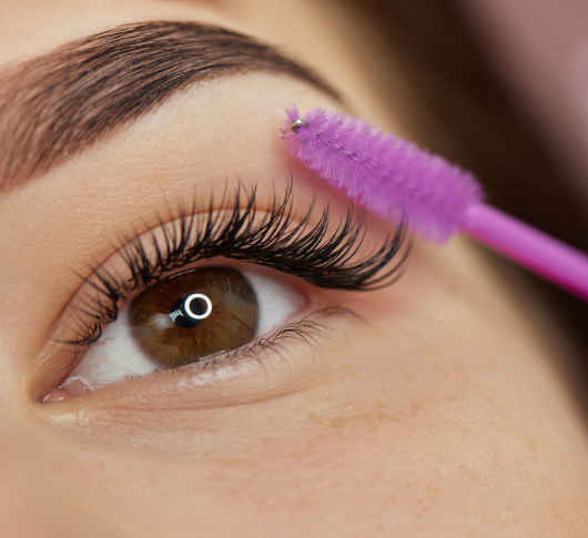 Applying mascara to shape eyebrows Close-up.