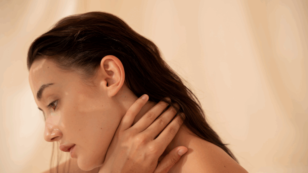 Natural beauty close-up of woman holding her neck