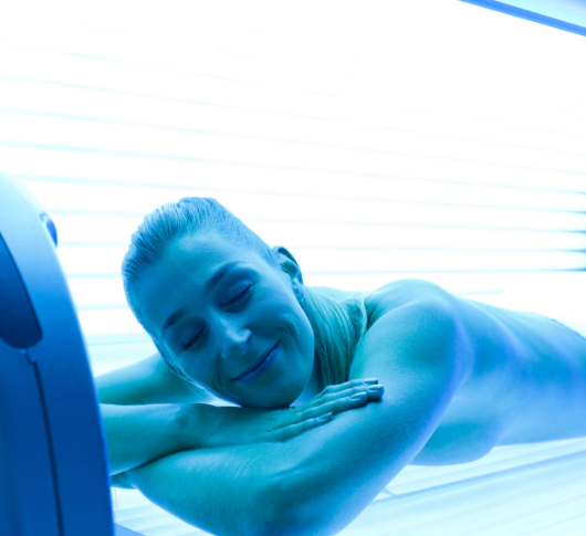 Woman enjoying tanning bed treatment